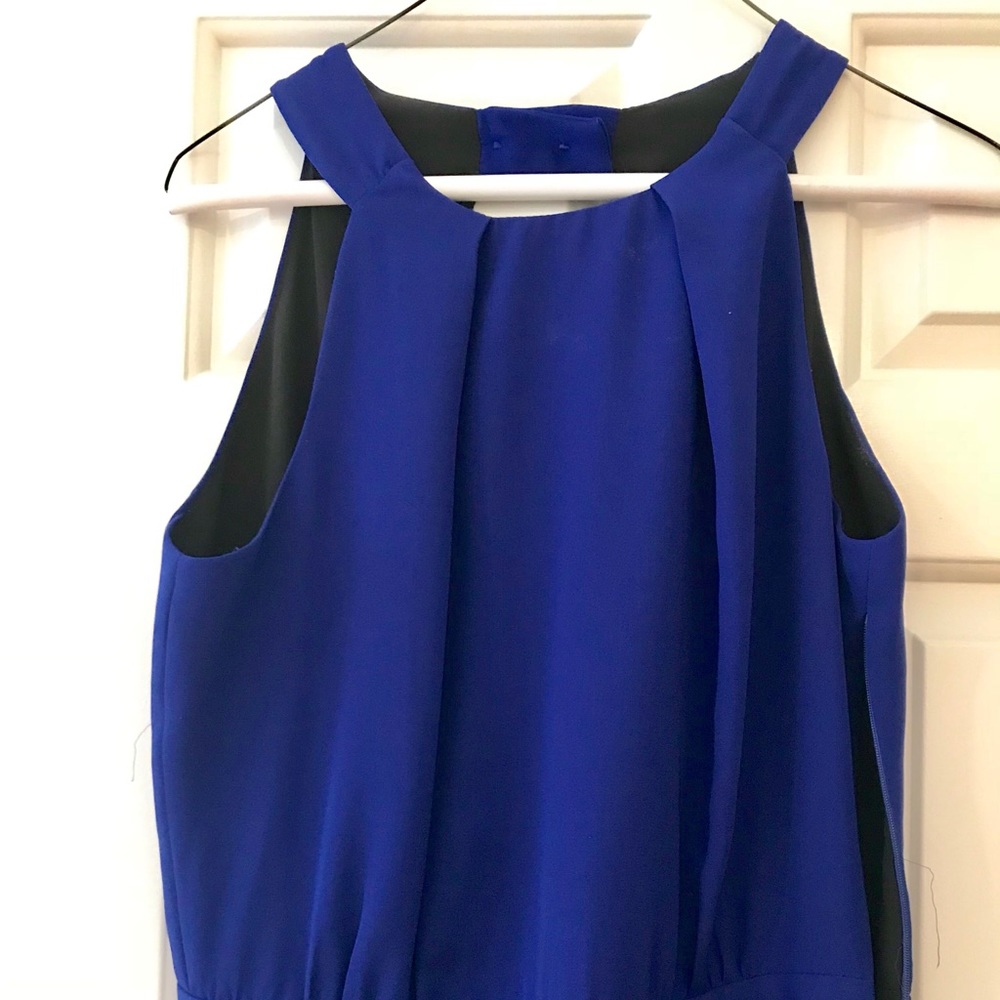 Blue jumpsuit from Zara. Open back and high neck.